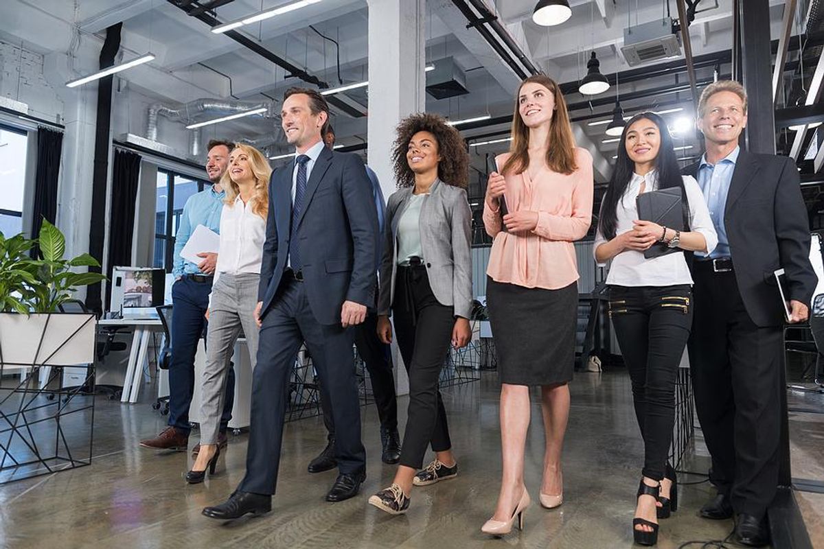 Leaders/executives and employees walking in an office