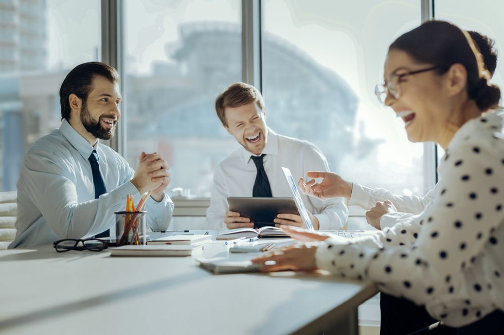 Leaders laughing together during a meeting