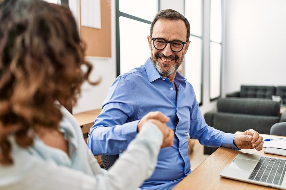 Leadership coach fist bumps his client