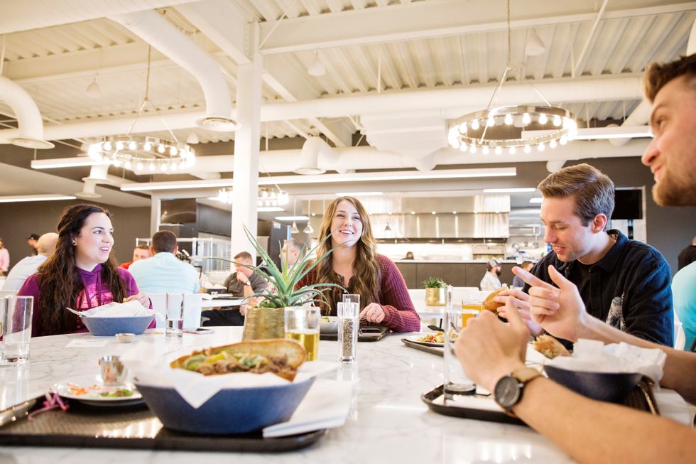 Malouf employees enjoy a healthy lunch in the Malouf kitchen.