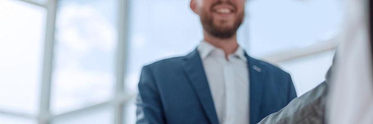 Man accepts a job offer and shakes hands with the hiring manager
