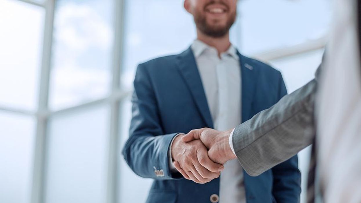 Man accepts a job offer and shakes hands with the hiring manager