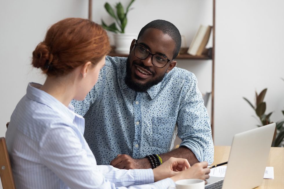 Man and woman flirt while at work