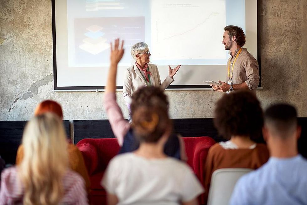 Man and woman talk during staff training and development