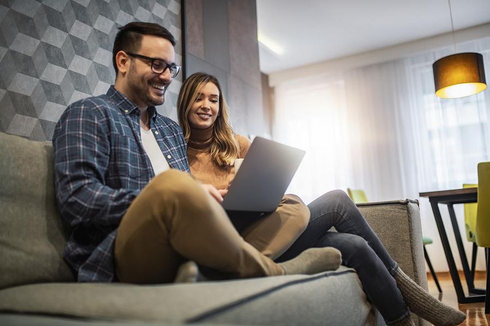 Man and woman use laptop together to take online career courses