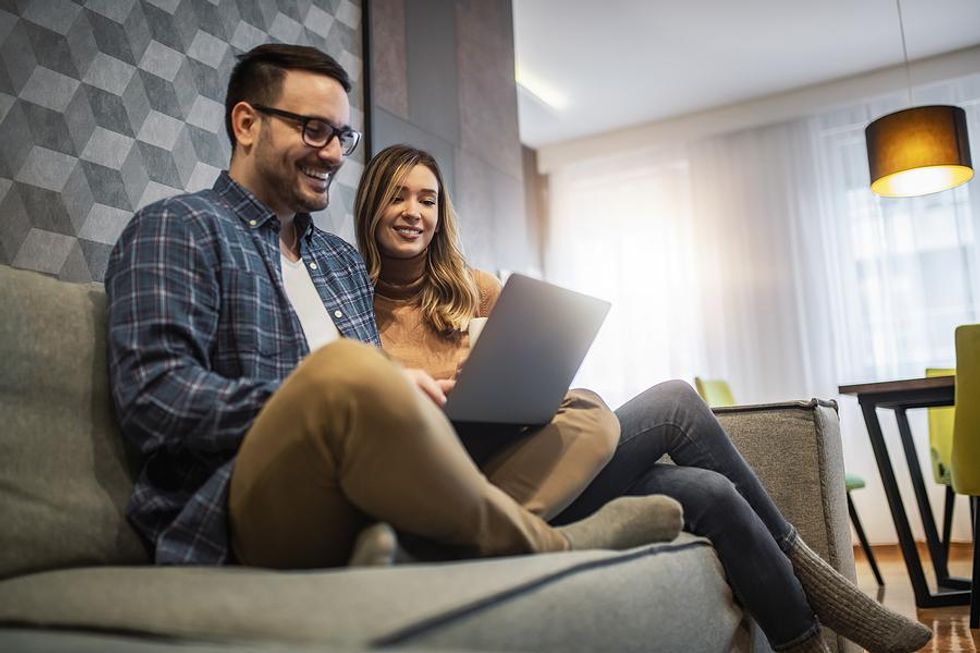 Man and woman use laptop together to take online career courses