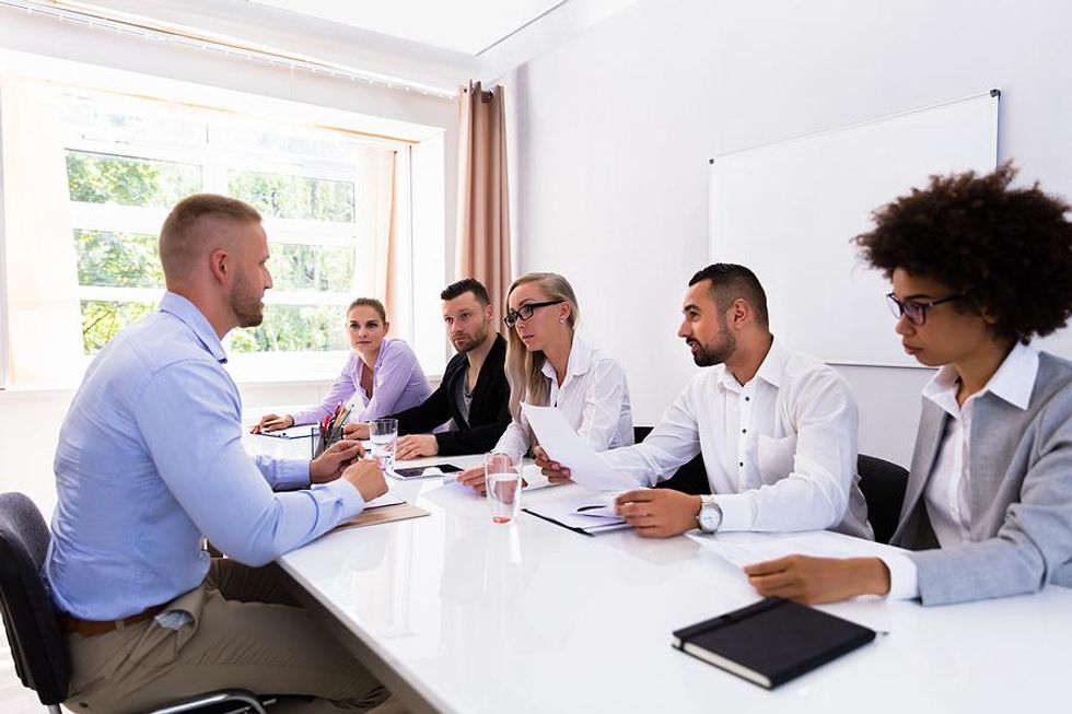 Man answers a question during a panel job interview