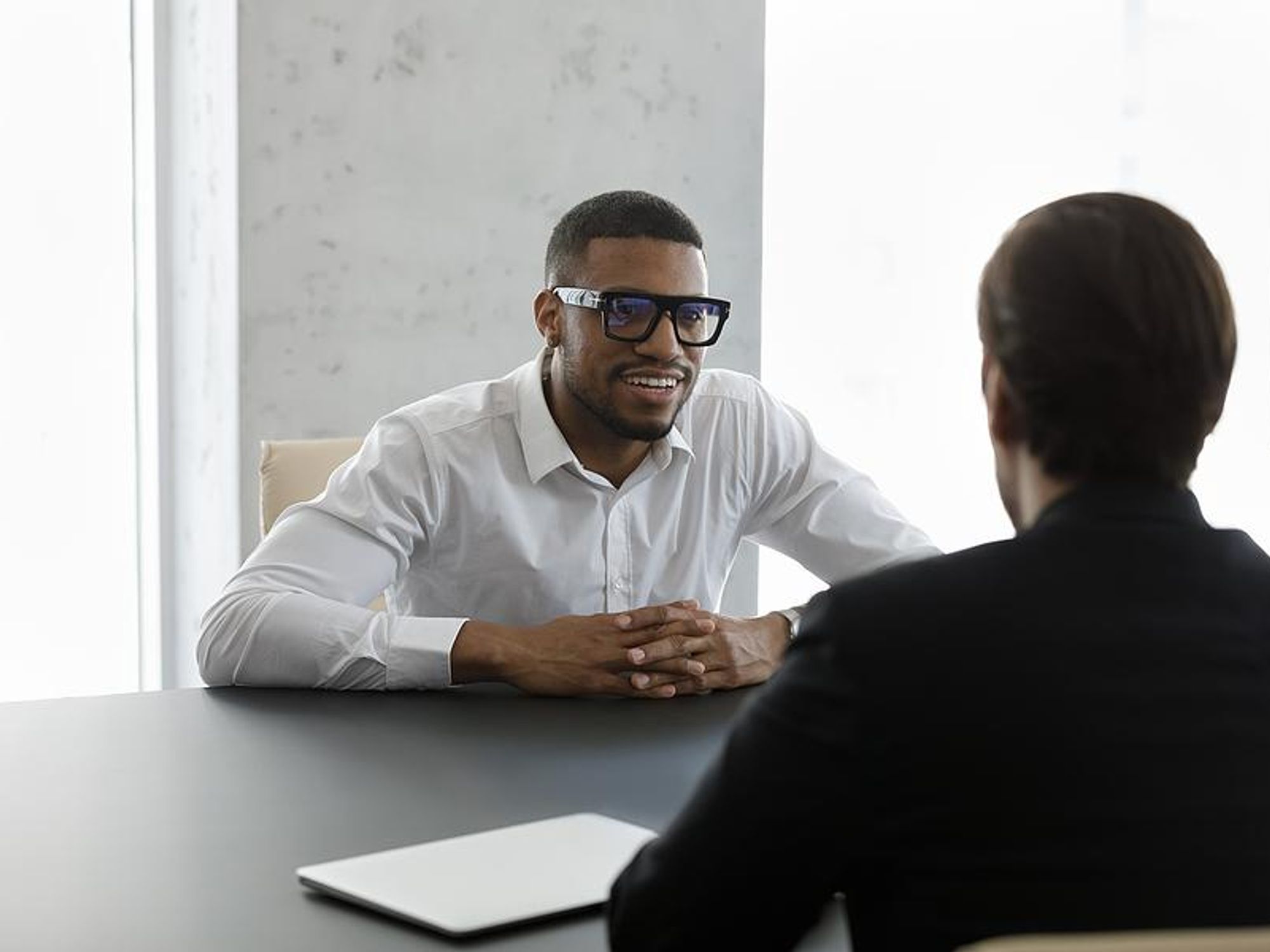 Man answers the interview question "describe yourself in one word"