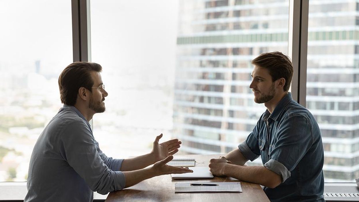 Man asks the hiring manager a question during his job interview