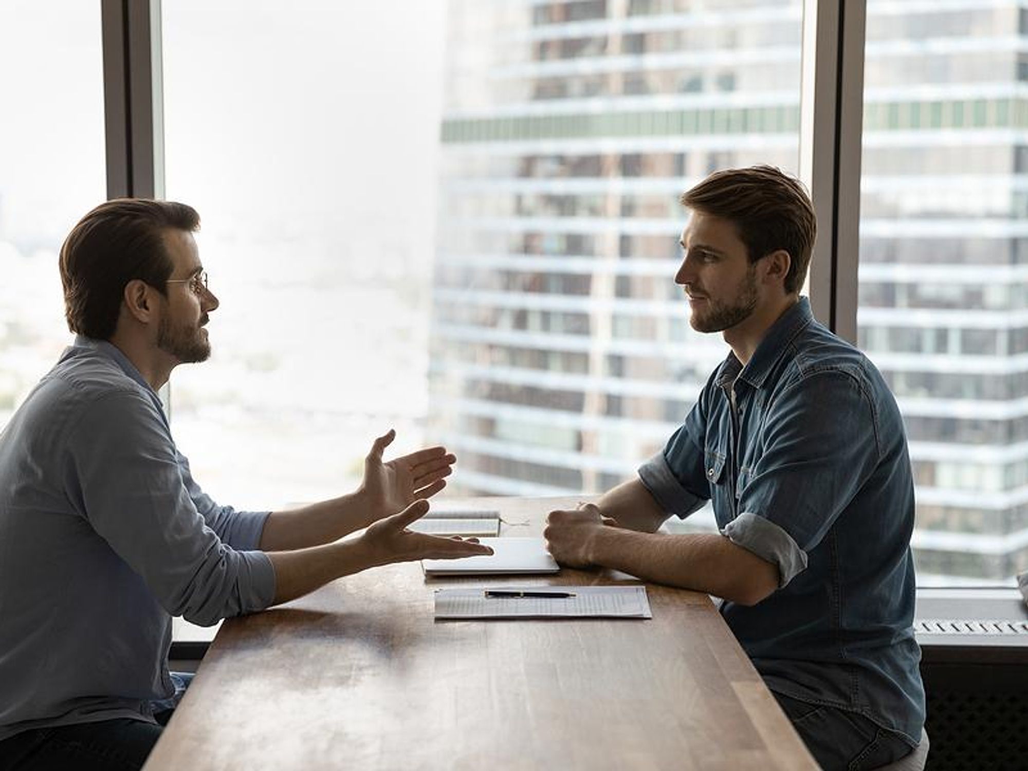 Man asks the hiring manager a question during his job interview