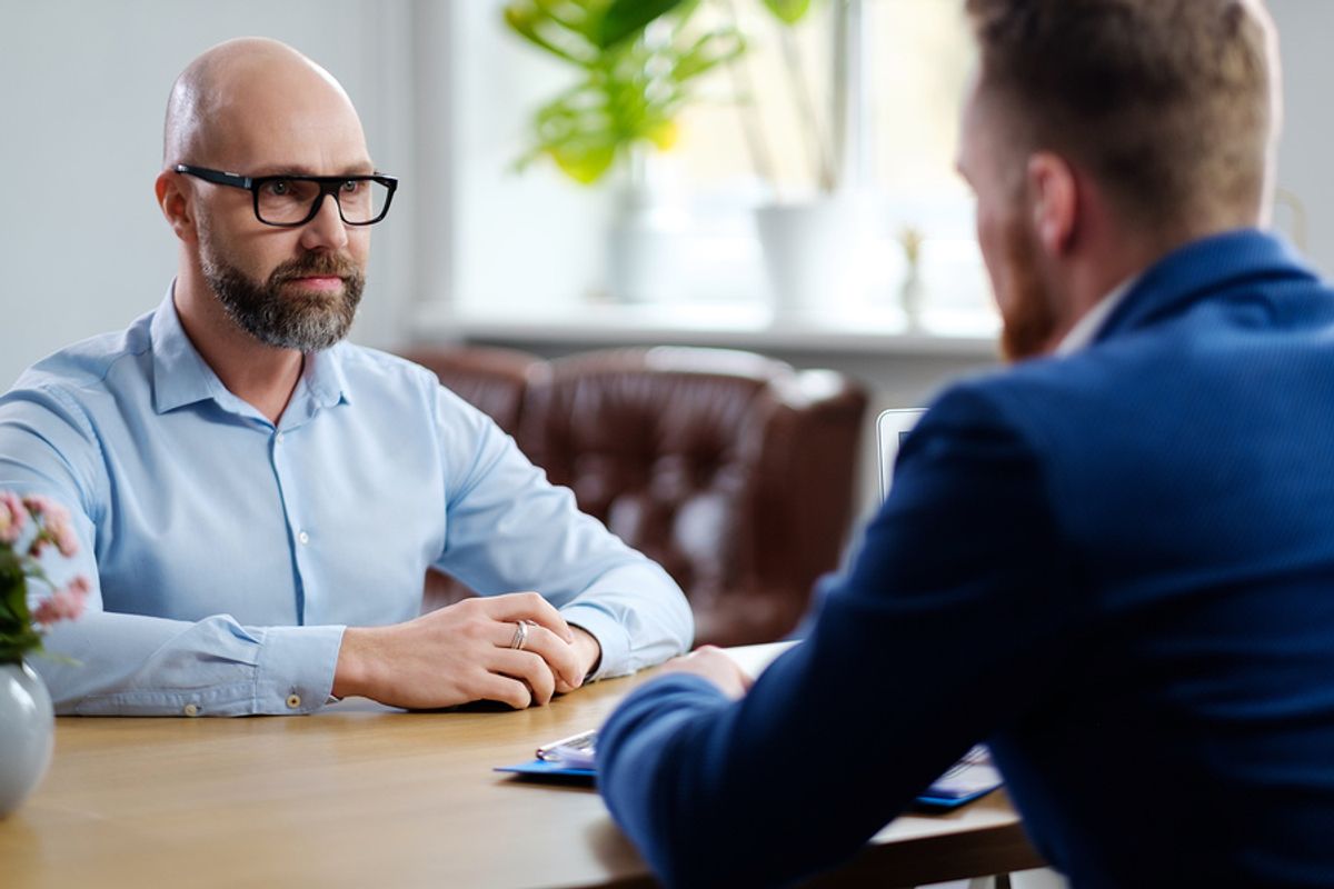 Man at a job interview afraid he'll be overqualified for the job