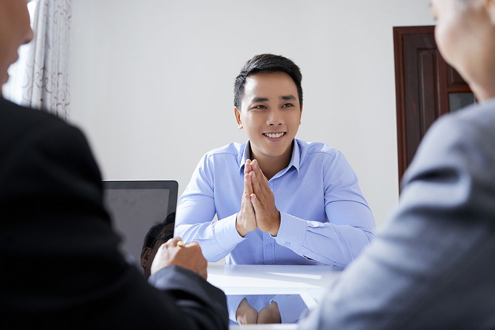 A man connects with his interviewers during a job interview