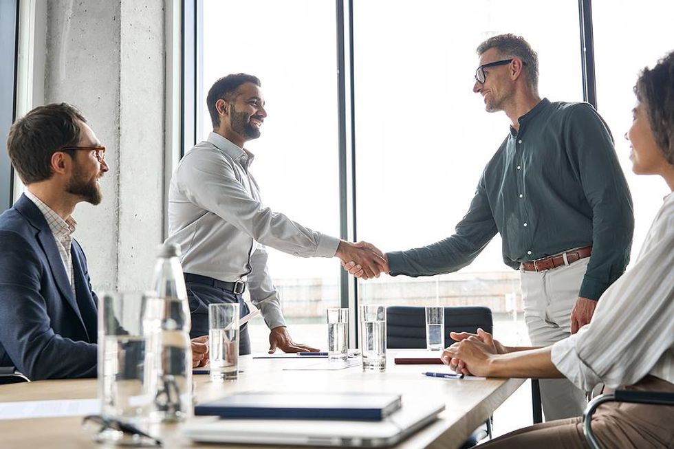 Man gets congratulated on his success at work