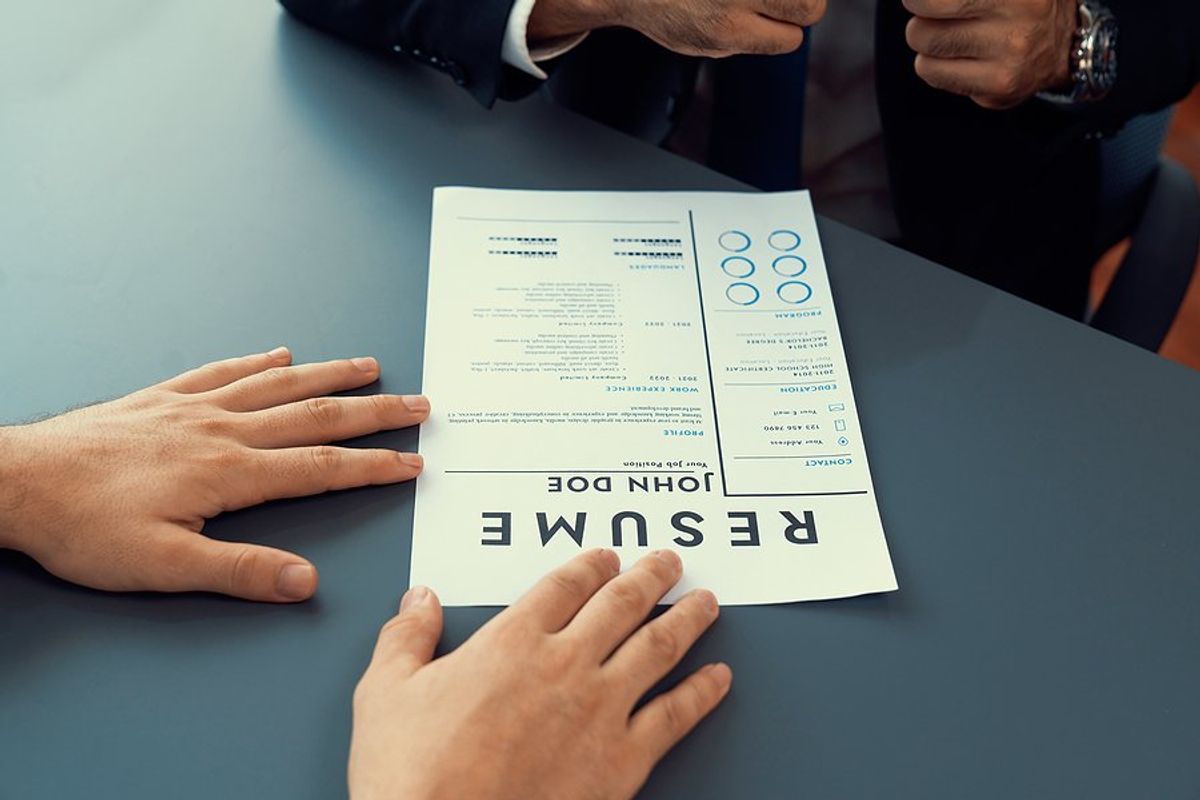 Man gives a hiring manager his resume in a job interview