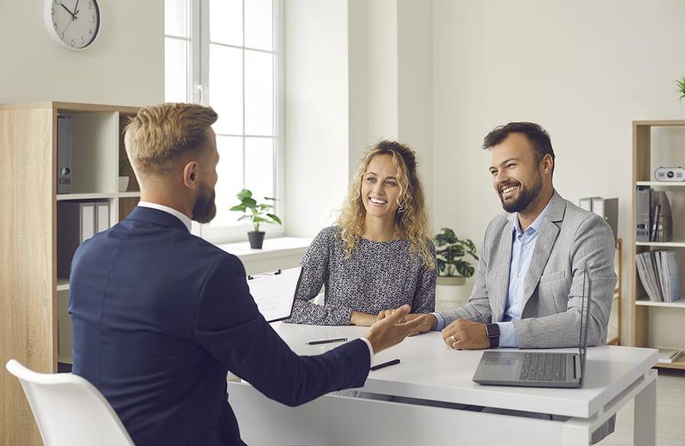 Man gives a sales presentation to potential customers