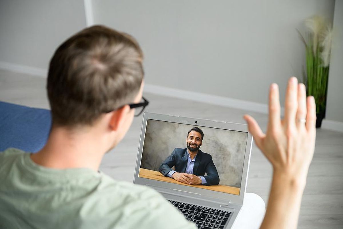 Man greets the employer before a virtual/video job interview