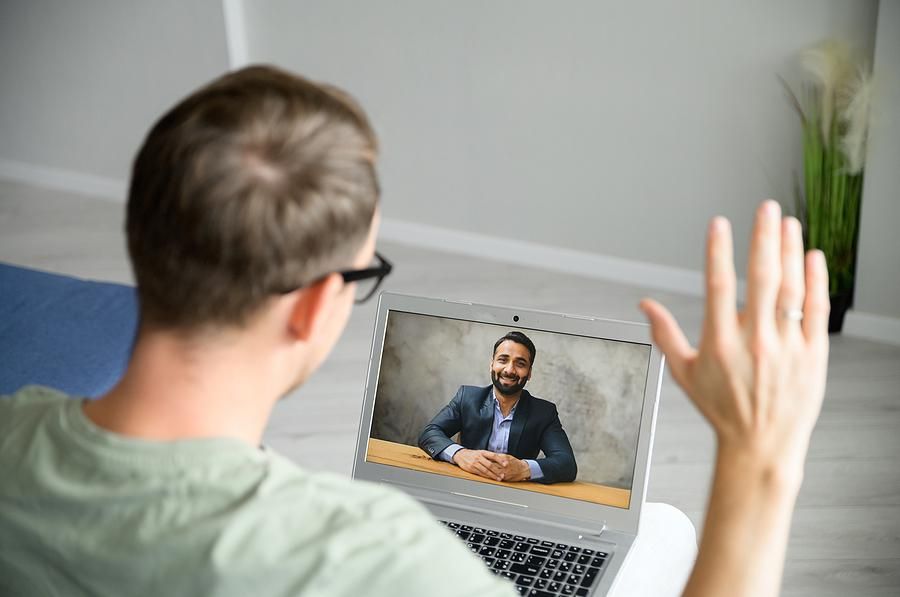 Man greets the employer before a virtual/video job interview