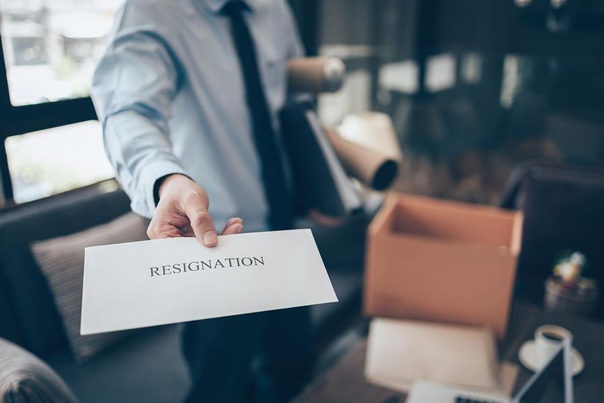 Man holding resignation letter quits his job