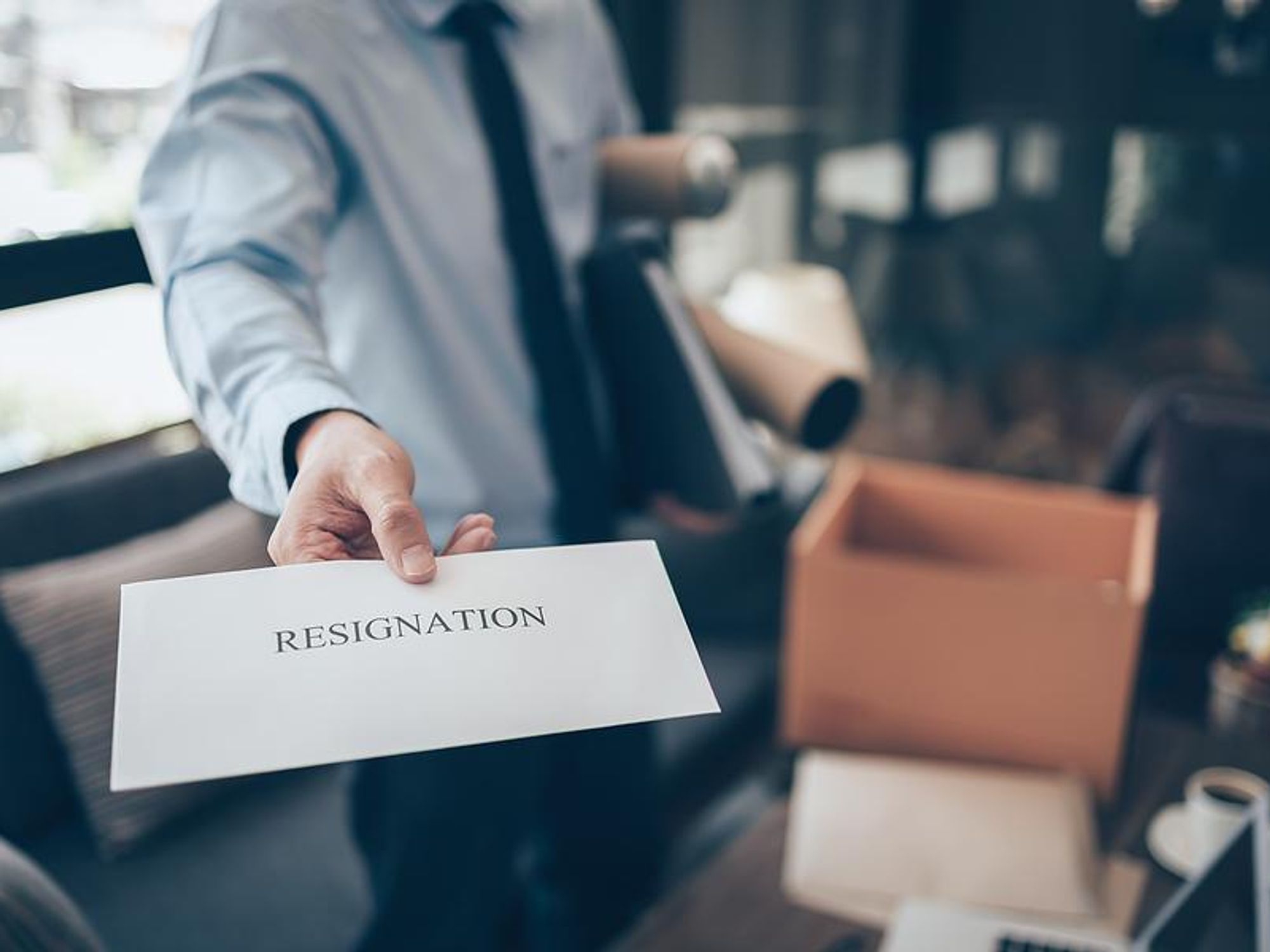 Man holding resignation letter quits his job