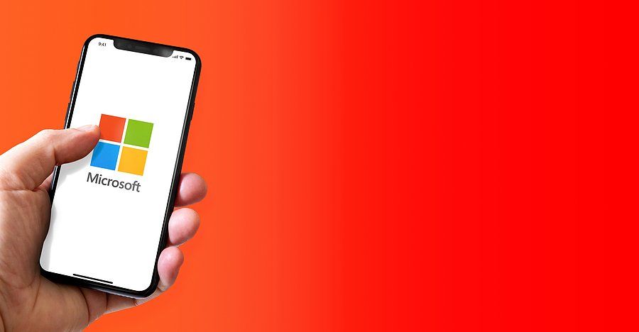 Man holds a phone powered by Microsoft Windows