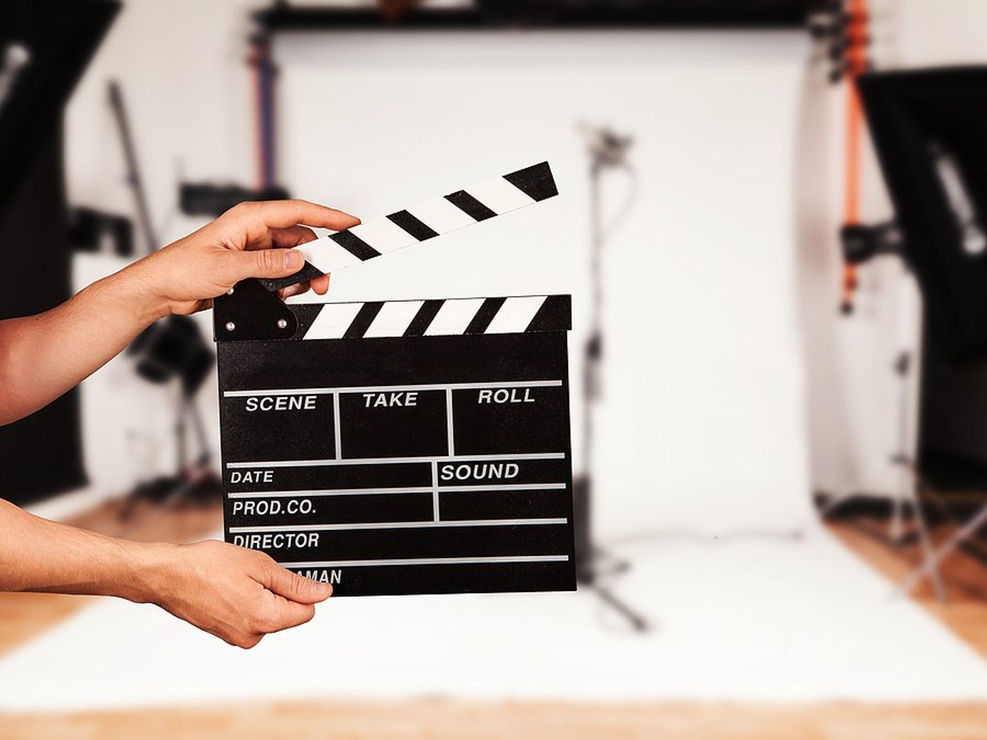 Man holds film clapper in a film studio (entertainment industry concept)