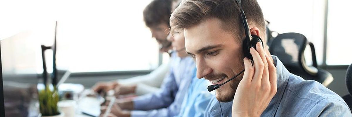 Man in call center talks to a customer