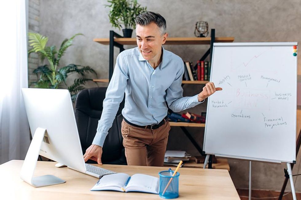 Man leads a virtual team meeting