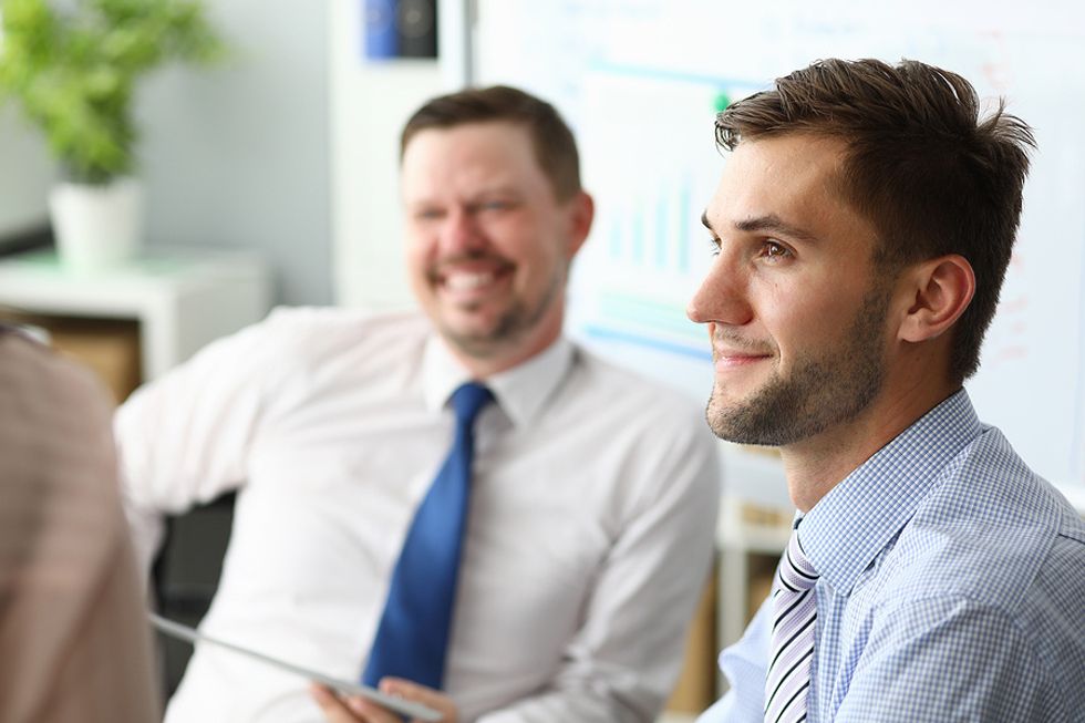 Man listens during a meeting at work