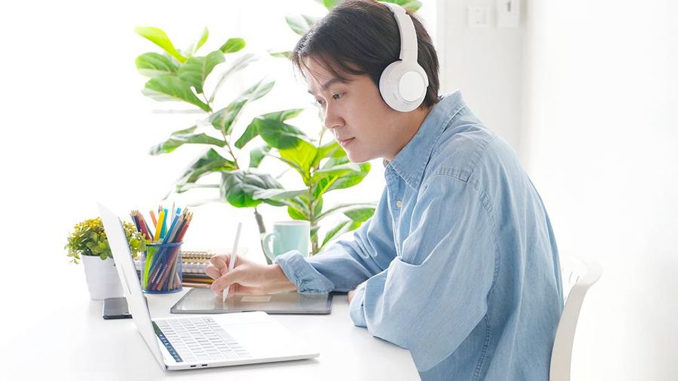 Man listens during a meeting for his work-from-anywhere job
