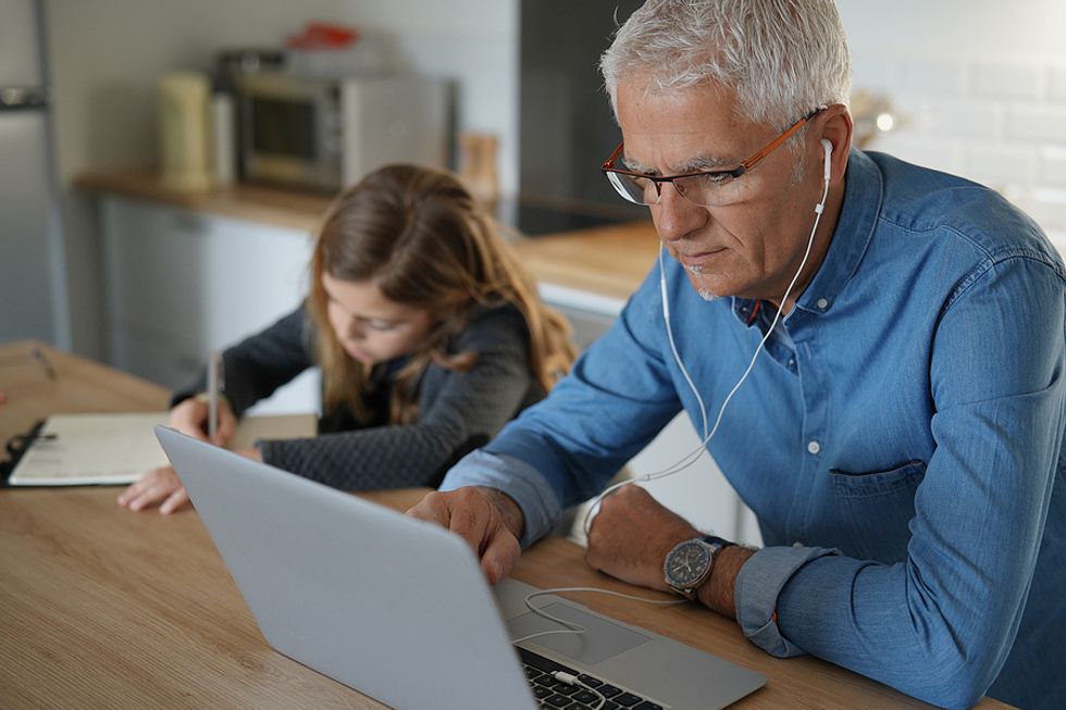 Man listens to a career coach on his laptop