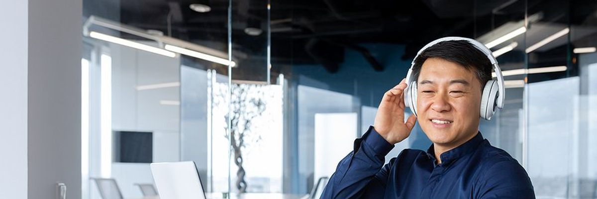 Man listens to a professional development podcast at work