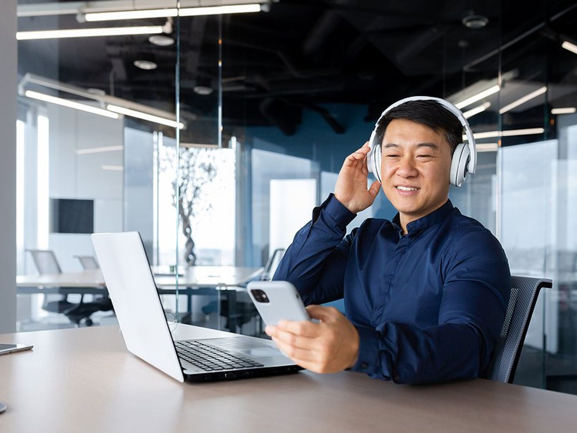 Man listens to a professional development podcast at work