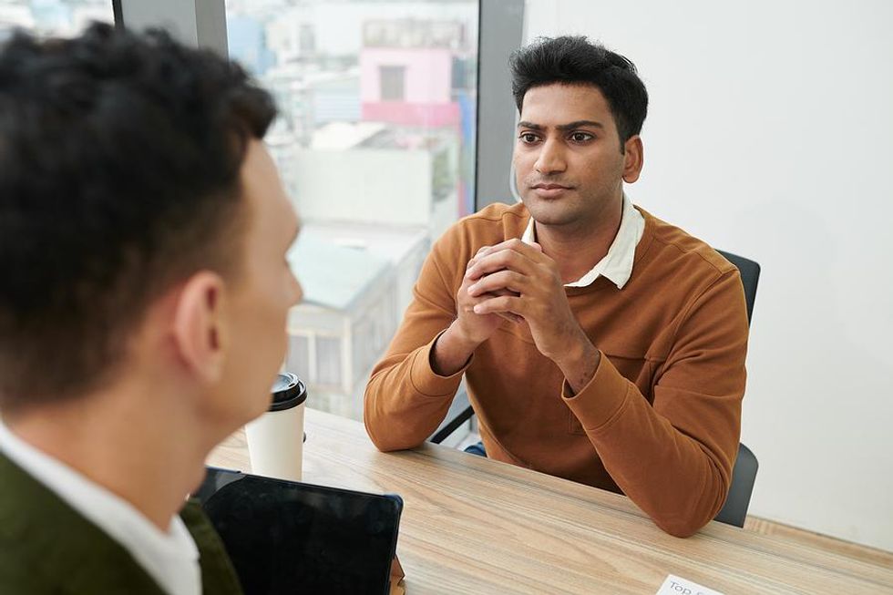 Man listens to a question during a job interview