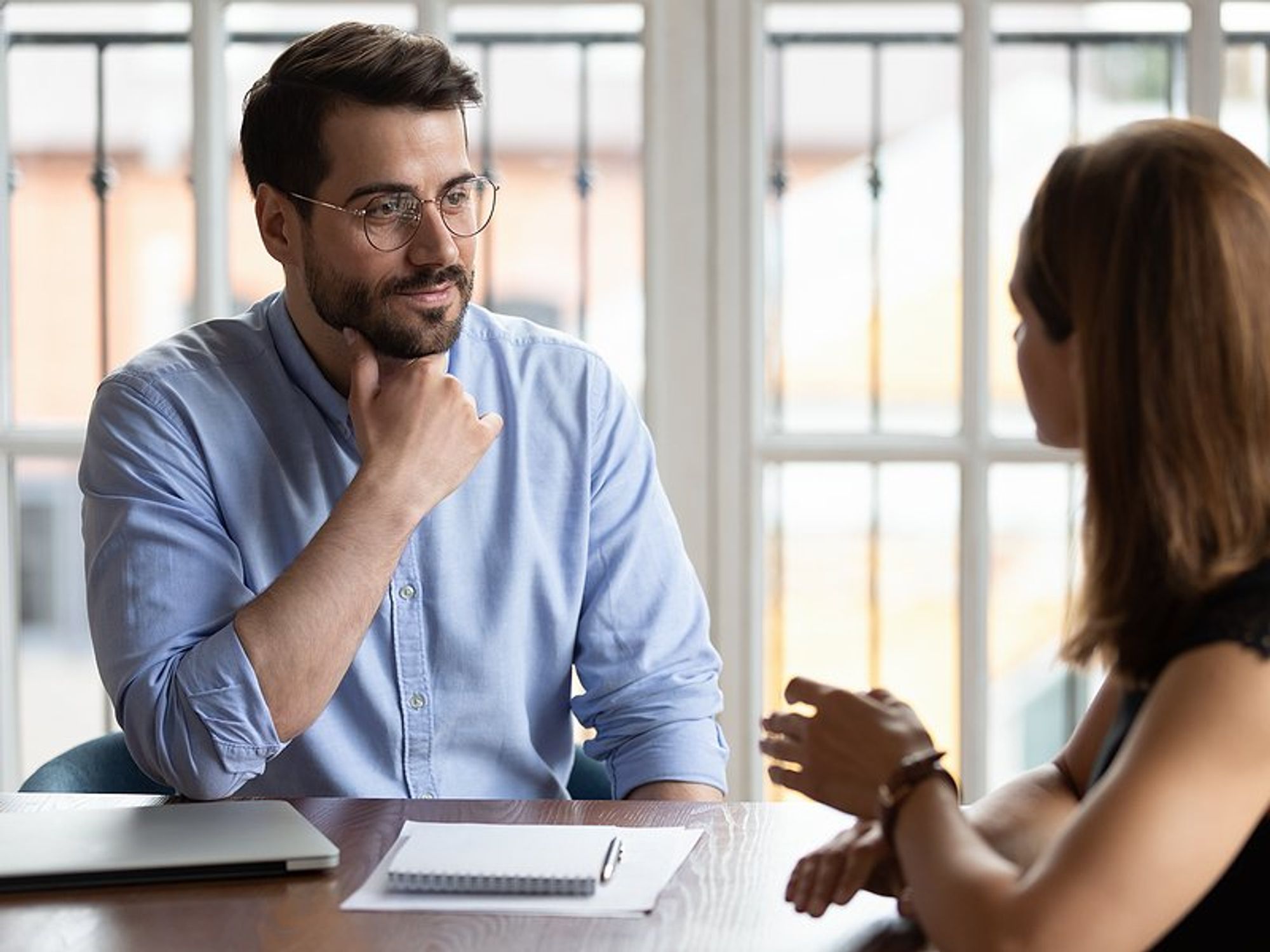 Man listens to hiring manager during a job interview