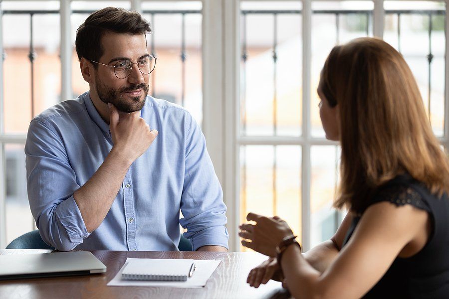 Man listens to hiring manager during a job interview