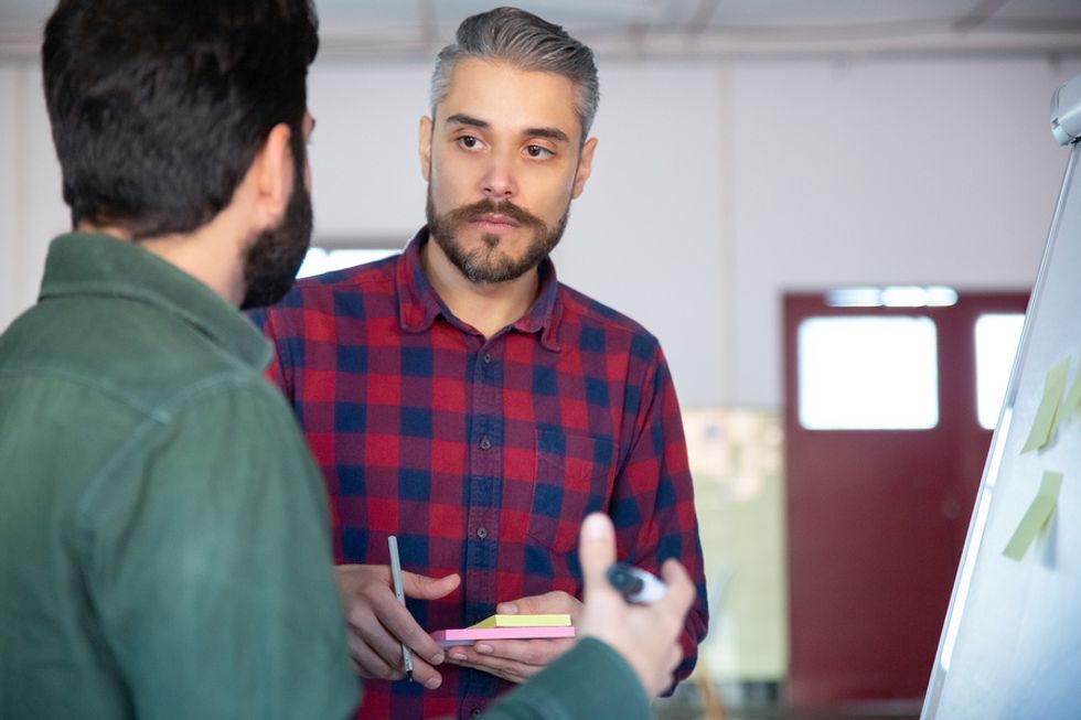 Man listens to his coworker during a meeting