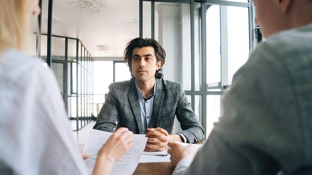 Man listens to the hiring manager ask a question during a job interview