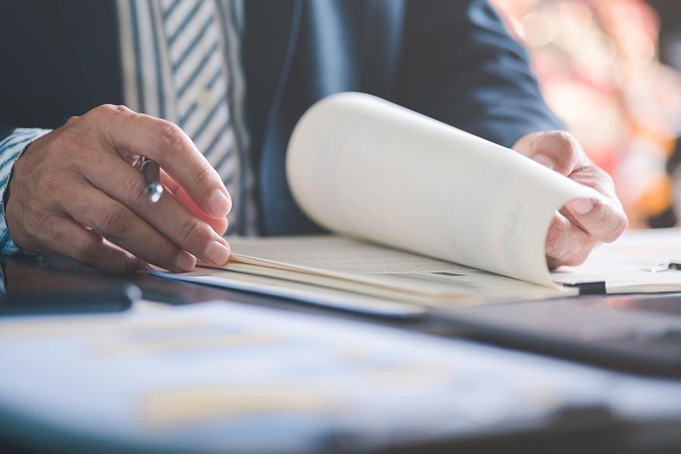 Man looks at and assesses documents