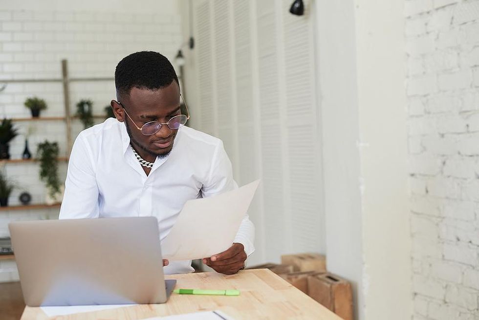 Man looks at his cover letter while on his laptop