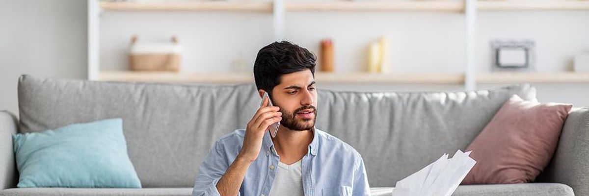 Man looks at his resume during a phone interview