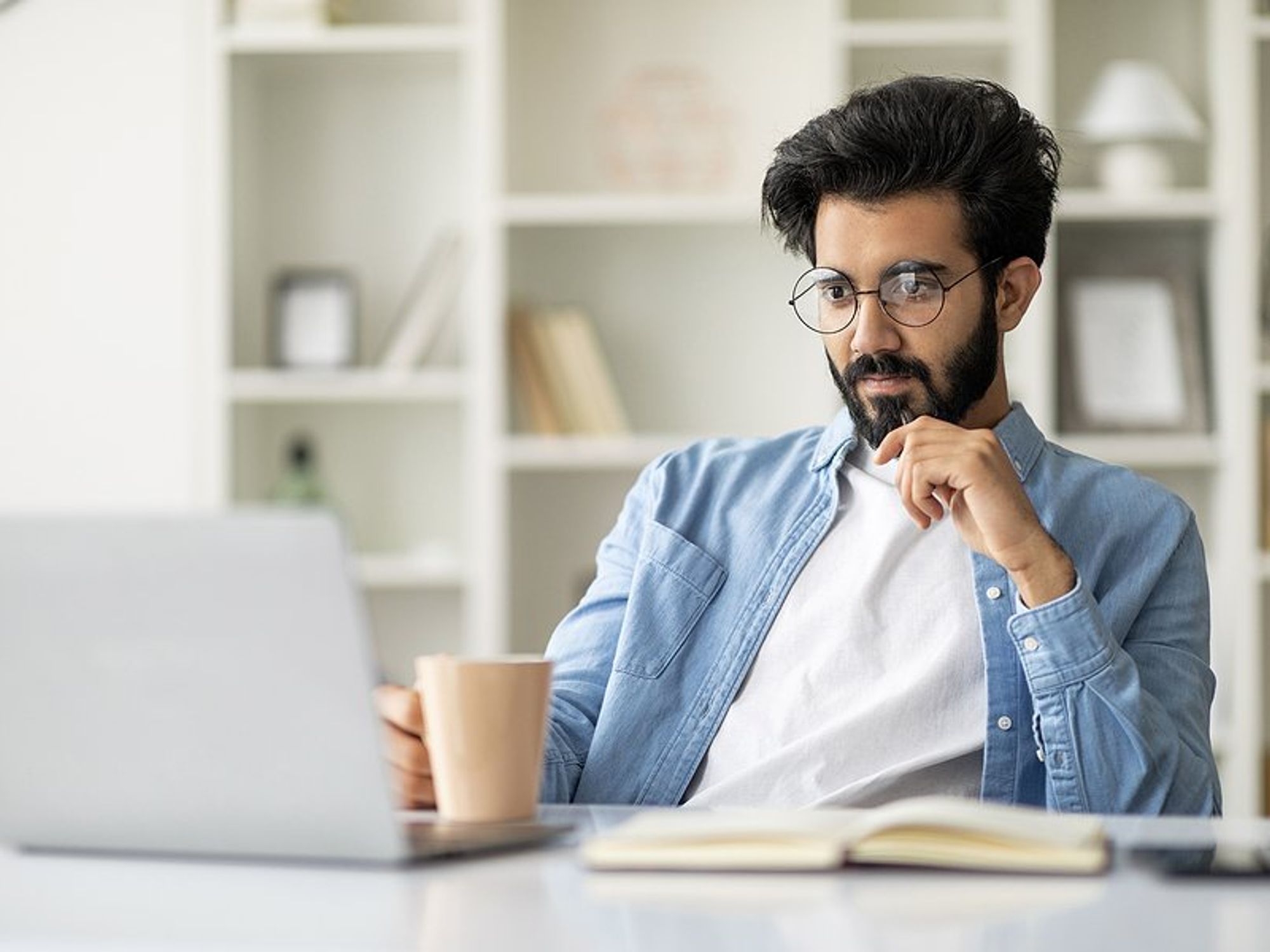 Man looks at MBA programs on his laptop