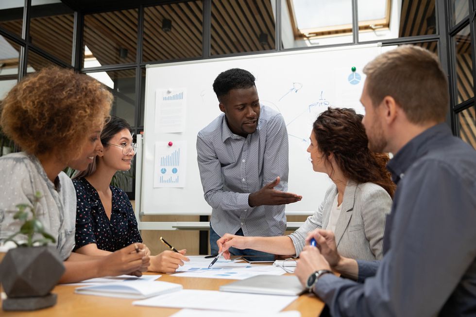 Man manages up at work during a meeting