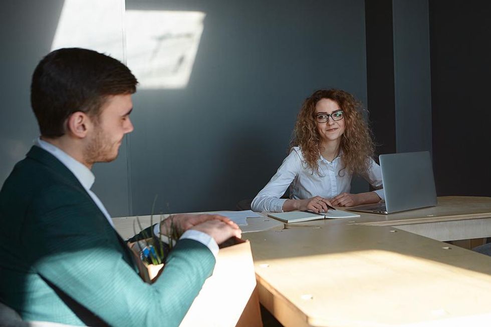 Man meets with his boss before leaving his job