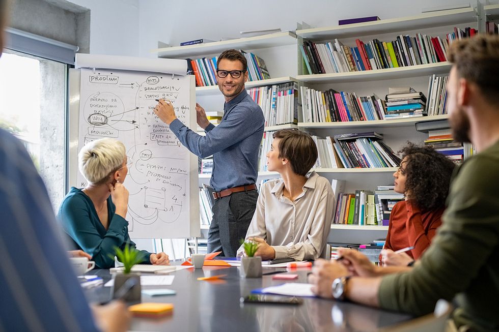 Man motivates his employees during a meeting