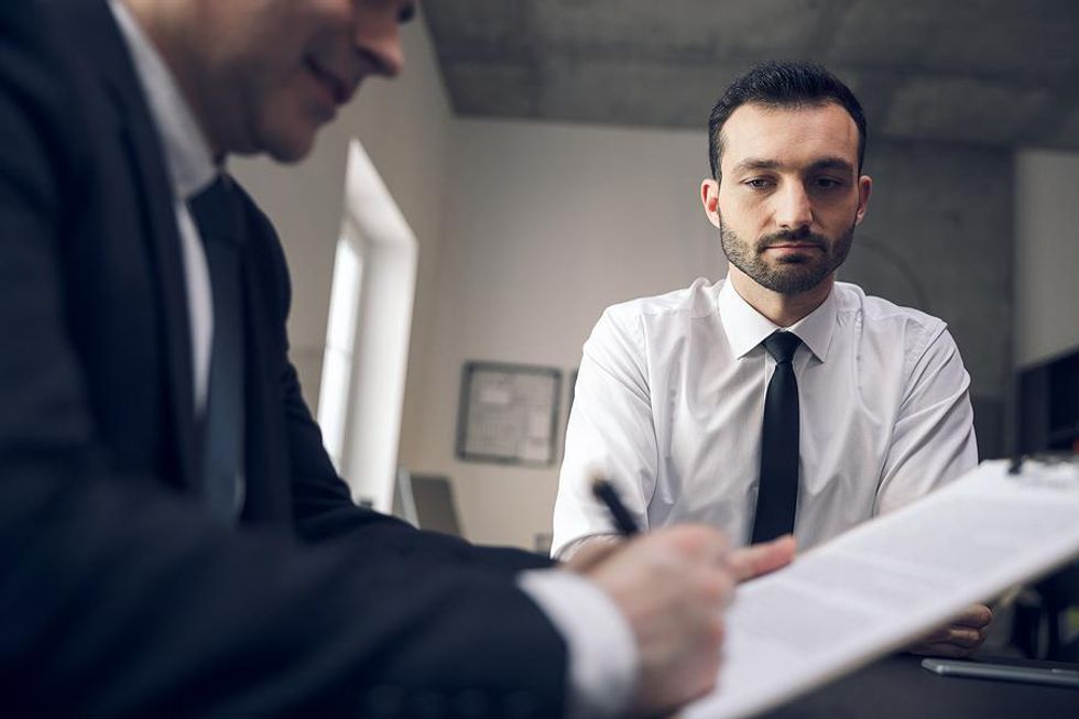 Man nervous about telling the hiring manager about his criminal record during an interview