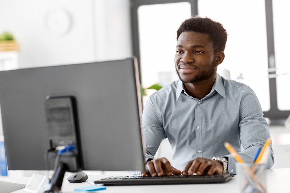 Man on computer takes Work It Daily's Career Decoder Quiz