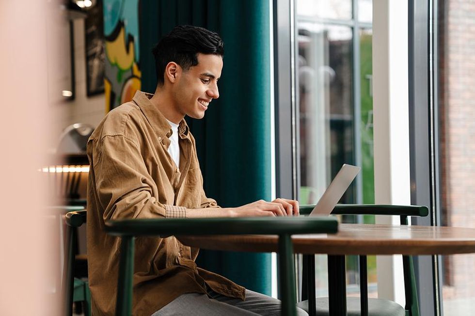 Man on laptop accepts a new connection request from someone on LinkedIn