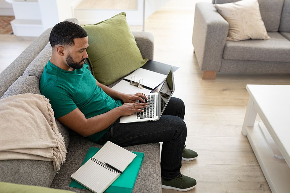 Man on laptop applying for a job during a tough job search