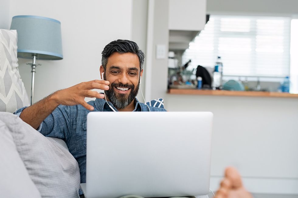 Man on laptop attends a virtual networking event and builds a community online