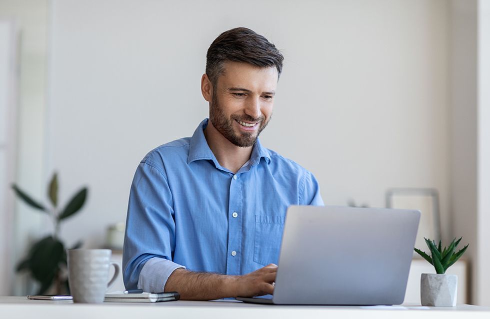 Man on laptop builds his personal brand on social media